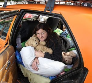 Jacqueline Carter on her bed in the back of her car.