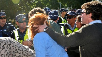 Protester Anthony Main grabs fellow protester Mel Gregson hair and head as she screams police brutality.  Police set up to protect drill workers in Alexander Parade, Fitzroy.  The drillers are taking core samples for the East West link Tunnel.    Pic. Nicole Garmston