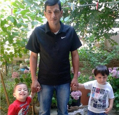 Aylan Kurdi happy with his father and brother